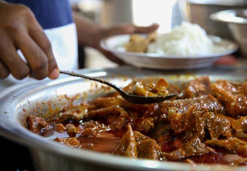 Header photo. Large soup pot filled with stew and meat.