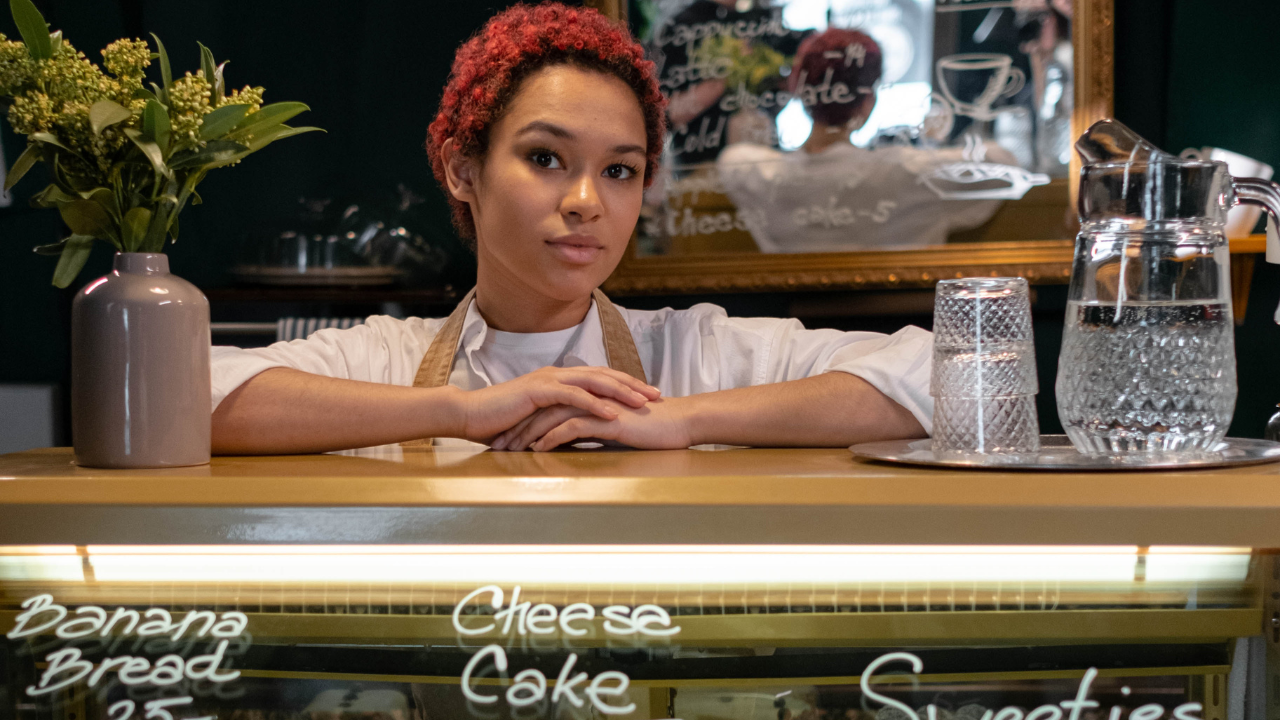 A woman behind a food counter