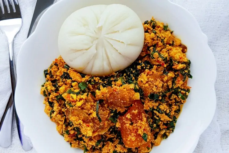 Pounded yam and egusi dished in white plate