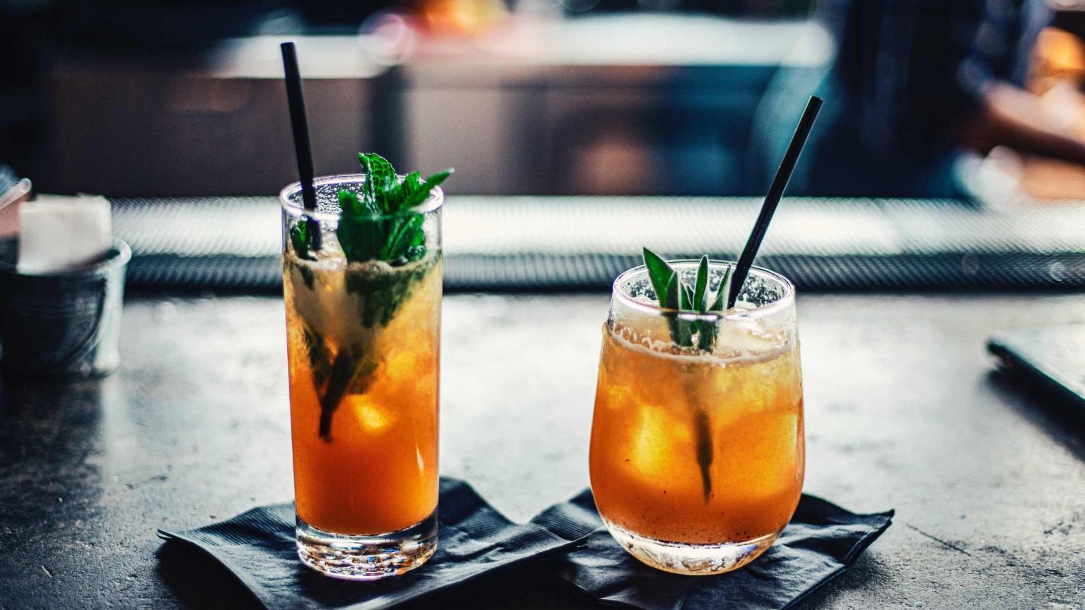 Two cocktails on a table at a restaurant bar