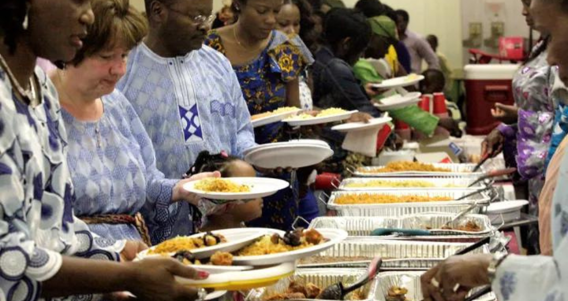 People at a Nigerian wedding serving food