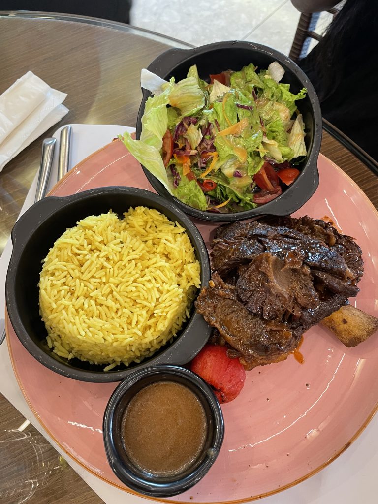 The barbecue beef ribs with coconut rice and a side salad at Brisk Lagos.