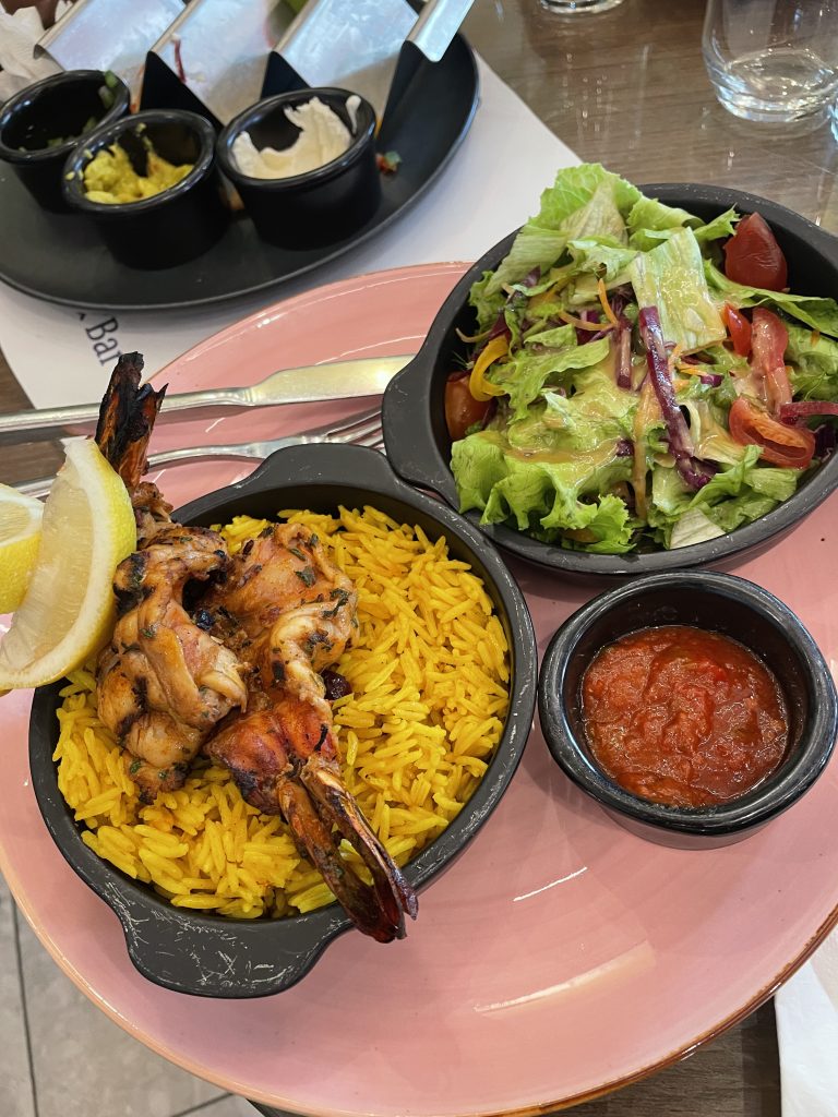 The jumbo prawns with saffron rice and a side salad at Brisk Lagos.