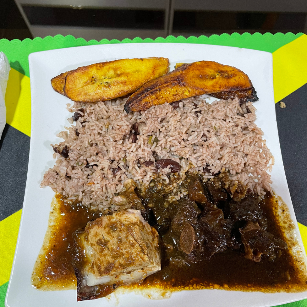 Brown stew oxtail, jerk pork, rice and peas and plantains at Jamski