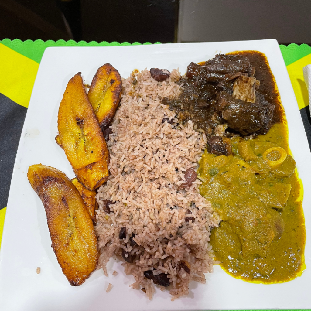 Brown stew oxtail, curry goat, rice and peas and plantains at Jamski