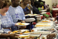 People at a Nigerian wedding serving food